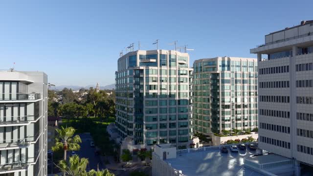 Low aerial view of the downtown streets, palm trees and homes at Bankers Hill.