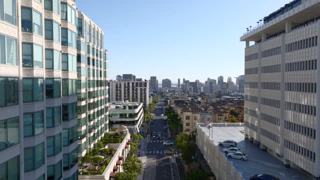 Low aerial view of the downtown streets, the skyline and the buildings at Bankers Hill.