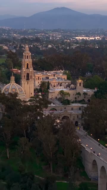 Aerial footage of Balboa Park California Tower and Cabrillo Bridge during a beautiful sunset over Bankers Hill | Vertical Drone Video