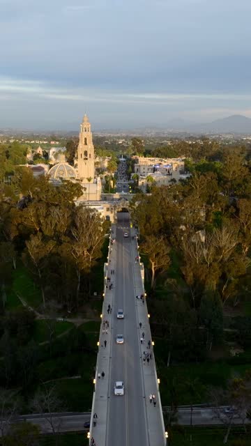 Aerial footage of Balboa Park California Tower and Cabrillo Bridge during a beautiful sunset over Bankers Hill | Vertical Drone Video – 7