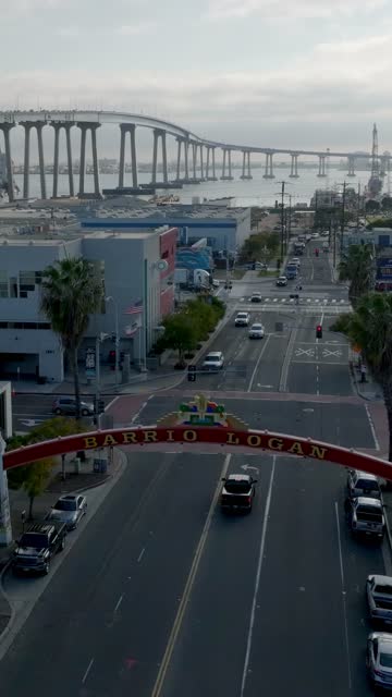 Low aerial view of the downtown streets, the bridge and the bay in Barrio Logan.