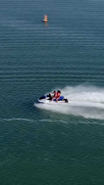 Aerial view of the country inland, boats and traffic in Carlsbad, with boats out.