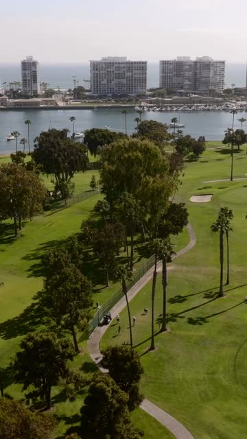 The Coronado Golf Course and Coronado Bridge on Glorietta Bay on a beaitiful Day | Vertical Drone Video