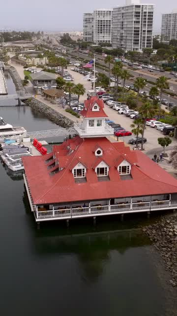 Bluewater Grill and Glorietta Bay Marina with the Boats Saliboats and yachts in Coronado | Vertical Drone Video