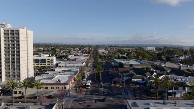 Low aerial view of the downtown streets, palm trees and homes in Chula Vista.