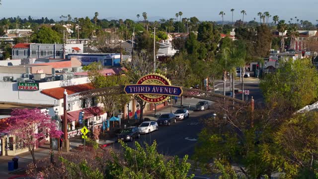 Low aerial view of the downtown streets, palm trees and the buildings in Chula Vista.