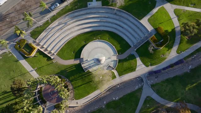 Aerial view of a park, palm trees and the buildings in Chula Vista, with people walking.