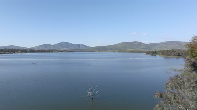 Low aerial view of the country inland, boats and open country in Chula Vista, with boats out.