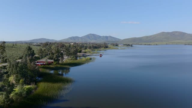 Low aerial view of the country inland, open country and the water in Chula Vista.
