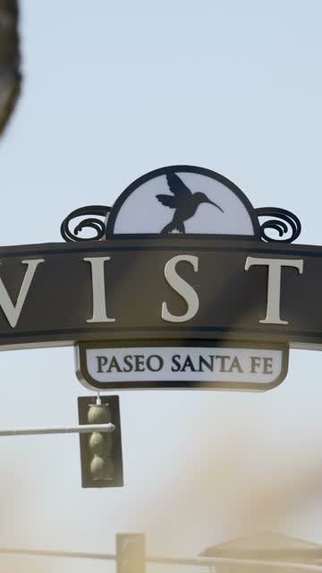Walking view of the Vista sign with nearby shops, restaurants and the energetic downtown scene | Vertical Video – 3