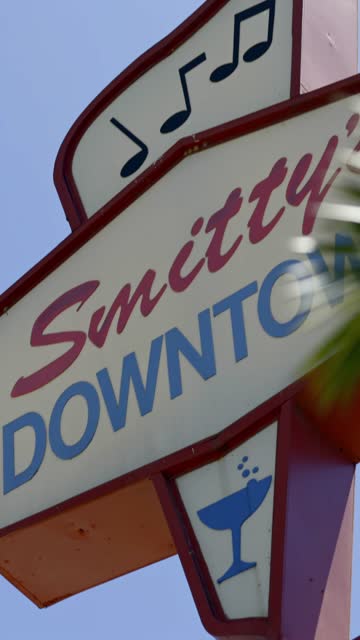 Walking view of the Vista sign with nearby shops, restaurants and the energetic downtown scene | Vertical Video – 5