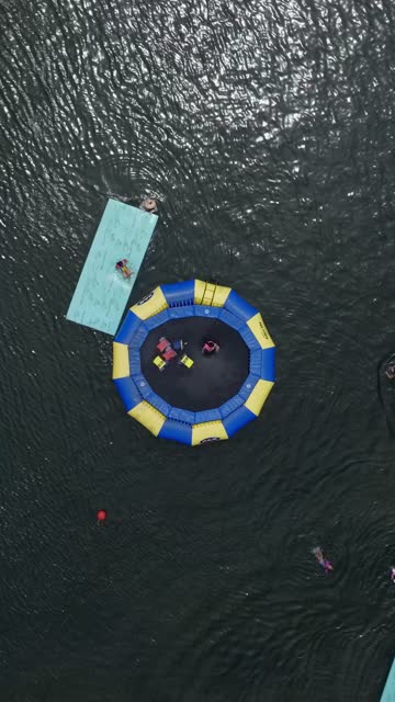 Aerial view of the beach, the bay and the water in Mission Bay, with swimmers in the water.