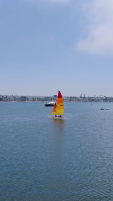 Low aerial view of the harbor, boats and the bay in Mission Bay, with boats out.
