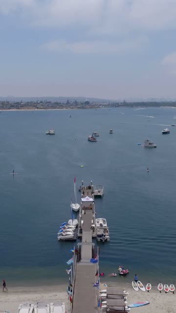 Aerial view of the harbor, the pier and boats in Mission Bay, with boats out.
