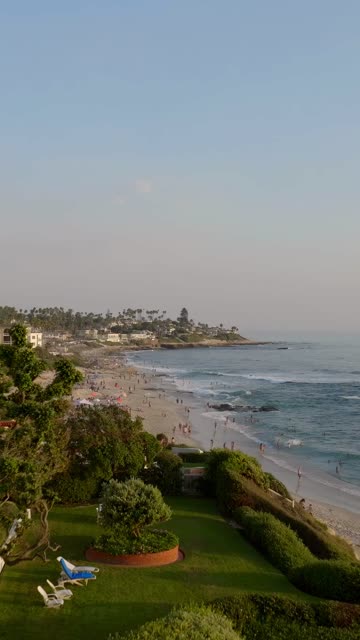 Beautiful afternoon at Windansea Beach in La Jolla with crowds enjoying the sun and beach activities at one of the most iconic beaches in San Diego | Vertical Drone Video – 4