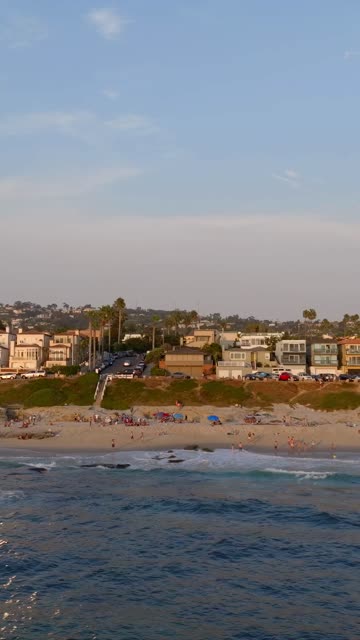 Beautiful afternoon at Windansea Beach in La Jolla with crowds enjoying the sun and beach activities at one of the most iconic beaches in San Diego | Vertical Drone Video – 5