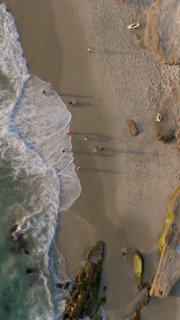 Beautiful afternoon at Windansea Beach in La Jolla with crowds enjoying the sun and beach activities at one of the most iconic beaches in San Diego | Vertical Drone Video – 6