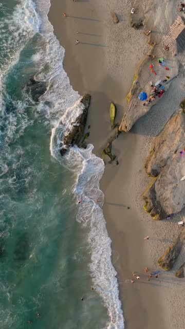 Beautiful afternoon at Windansea Beach in La Jolla with crowds enjoying the sun and beach activities at one of the most iconic beaches in San Diego | Vertical Drone Video – 7