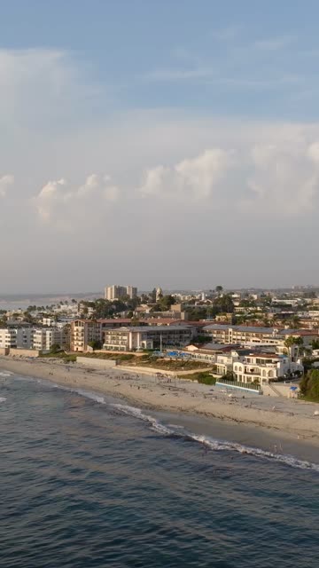 Beautiful afternoon at Windansea Beach in La Jolla with crowds enjoying the sun and beach activities at one of the most iconic beaches in San Diego | Vertical Drone Video – 9