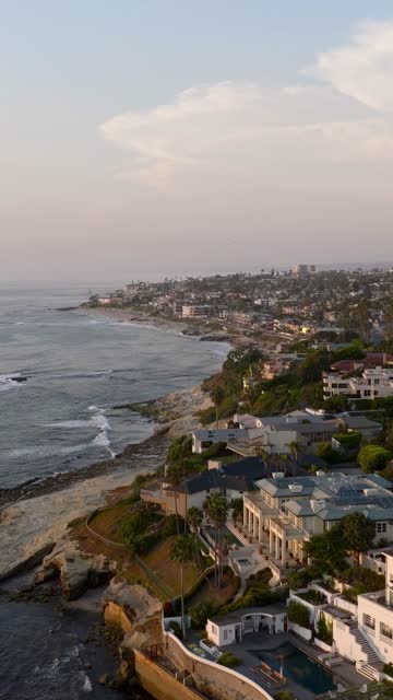 Beautiful afternoon at Windansea Beach in La Jolla with crowds enjoying the sun and beach activities at one of the most iconic beaches in San Diego | Vertical Drone Video – 11