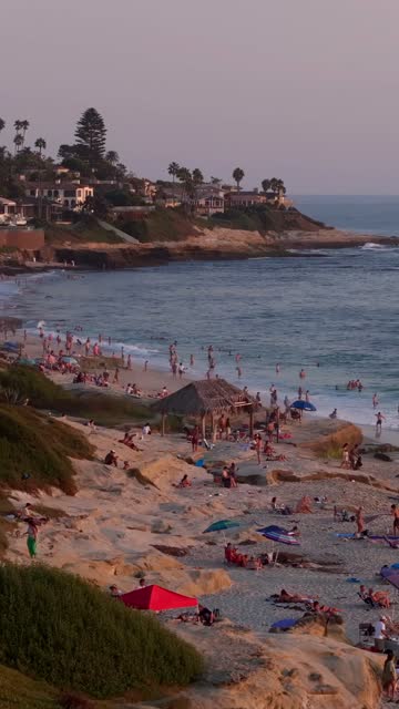 Beautiful afternoon at Windansea Beach in La Jolla with crowds enjoying the sun and beach activities at one of the most iconic beaches in San Diego | Vertical Drone Video – 12
