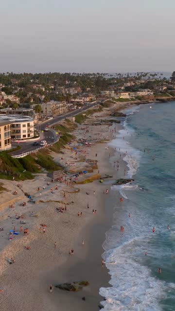 Beautiful afternoon at Windansea Beach in La Jolla with crowds enjoying the sun and beach activities at one of the most iconic beaches in San Diego | Vertical Drone Video – 13