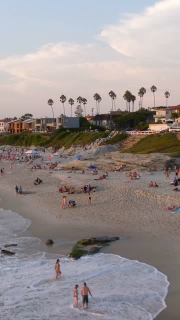 Beautiful afternoon at Windansea Beach in La Jolla with crowds enjoying the sun and beach activities at one of the most iconic beaches in San Diego | Vertical Drone Video – 14