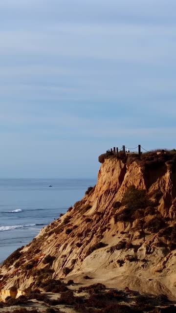 Low aerial view of the cliffs, the ocean and the beach in Del Mar.