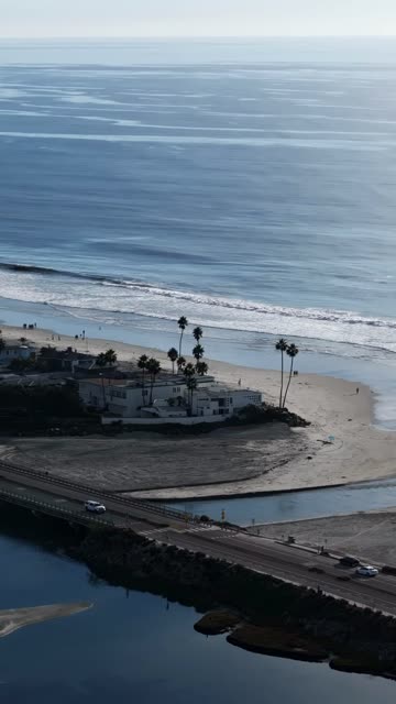Aerial view of the beach, the surf and the bridge in Del Mar.