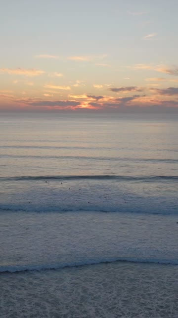 Aerial Drone Video of La Jolla and Bird Rock Coastline near Calumet Park with Surfers in the Water and Beach Views at Sunset