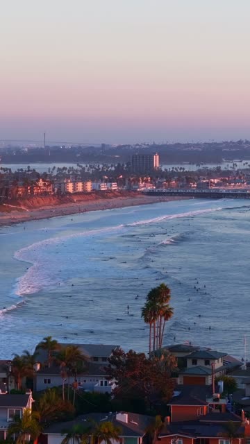 Aerial view of the beach, the surf and the pier at Bird Rock, with surfers out.
