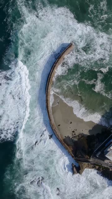 Aerial view of the beach, the surf and the ocean at Village of La Jolla.