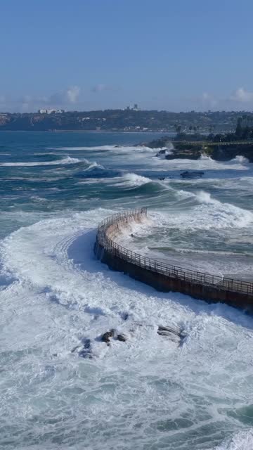 Aerial view of the cliffs, the surf and the ocean at Village of La Jolla.