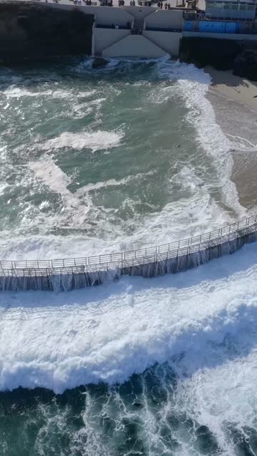 Aerial view of the cliffs, the surf and the ocean at Village of La Jolla.