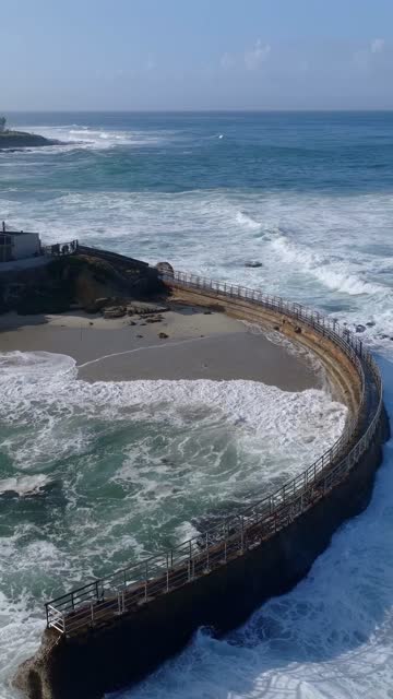 Aerial view of the beach, the surf and the ocean at Village of La Jolla.