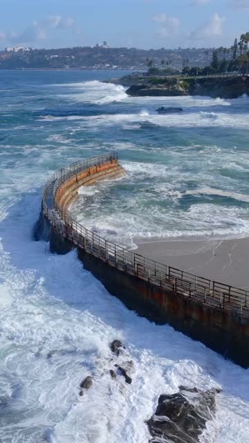 Aerial view of the beach, the surf and the ocean at Village of La Jolla.