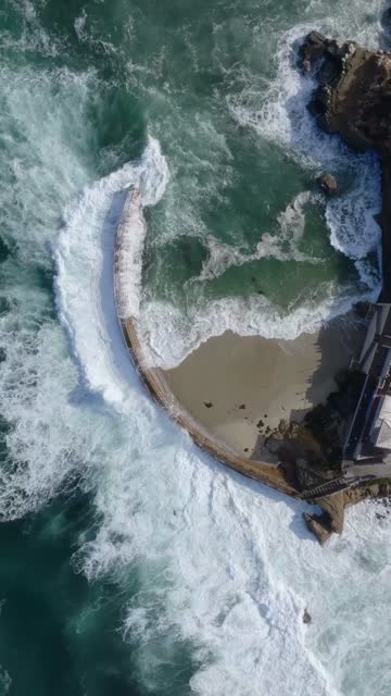Aerial view of the beach, the surf and the ocean at Village of La Jolla.