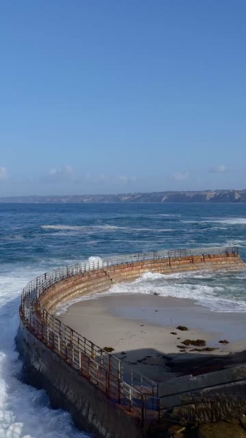 Low aerial view of the beach, the ocean and open country at Village of La Jolla.
