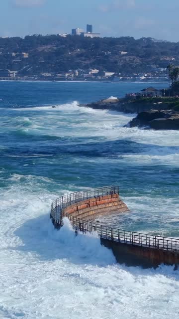 Aerial view of the cliffs, the surf and the ocean at Village of La Jolla.