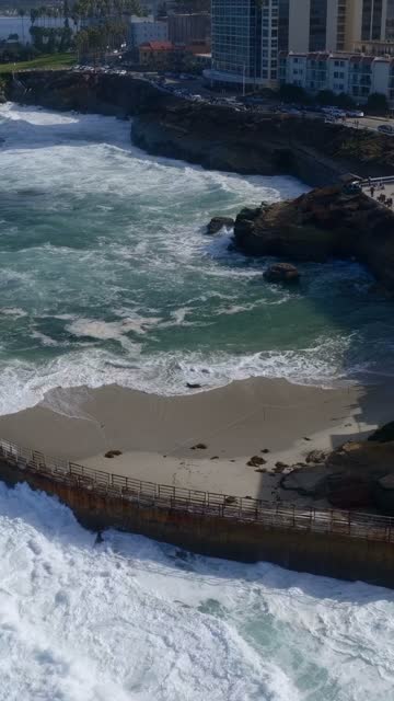 Aerial view of the beach, the surf and the ocean at Village of La Jolla.