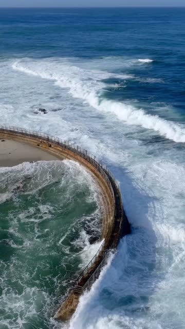 Aerial view of the beach, the surf and the ocean at Village of La Jolla.