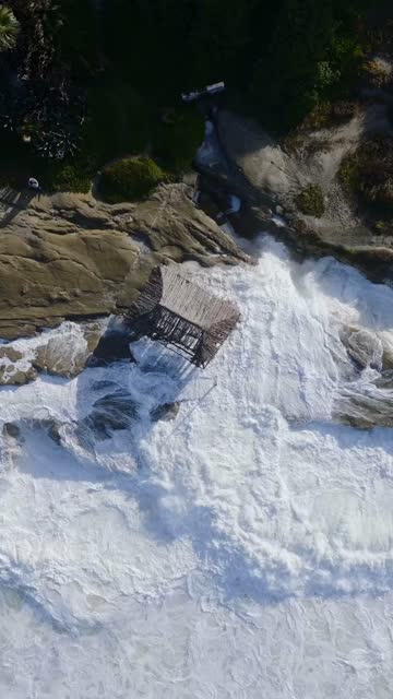 Aerial view of the cliffs, the surf and the ocean at Beach Barber Tract.