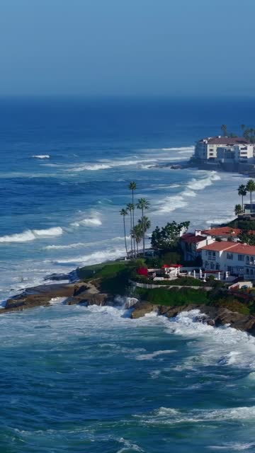 Aerial view of the cliffs, the surf and palm trees at Beach Barber Tract.