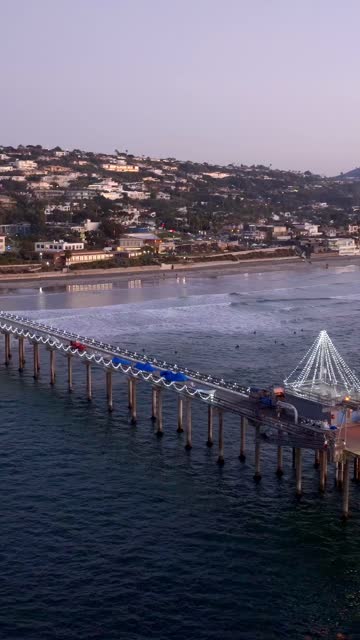 Aerial view of the beach, the surf and the pier at Black’s Beach.