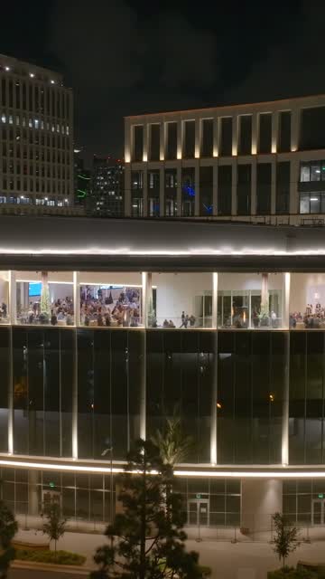 The downtown streets, palm trees and the buildings at Embarcadero, with a crowd gathered.