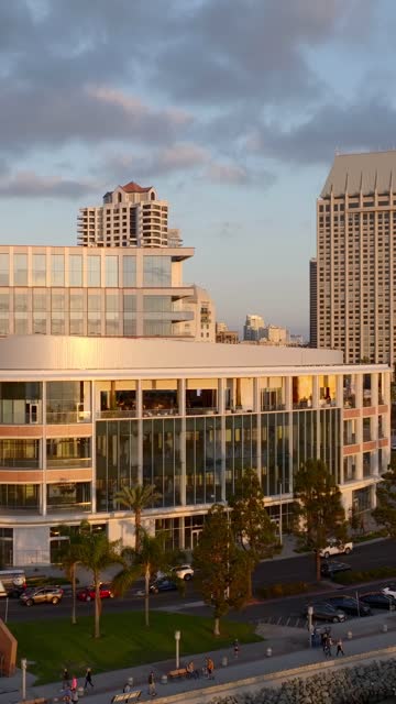Low aerial view of the downtown streets, the skyline and palm trees at Embarcadero, with people walking.