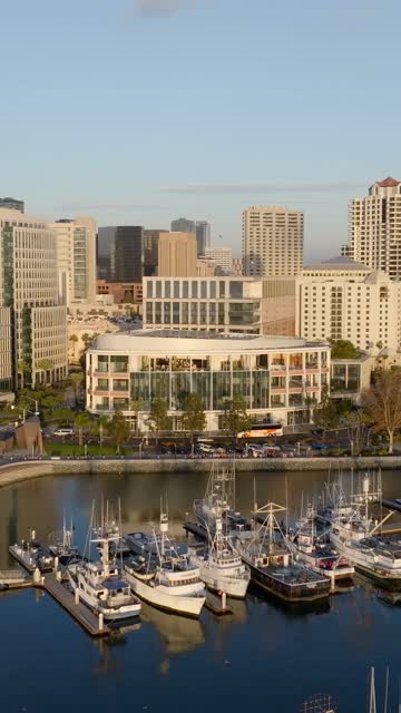 Low aerial view of the harbor, the skyline and boats at Embarcadero, with boats out.