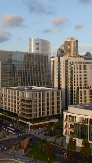 Low aerial view of the downtown streets, the skyline and palm trees at Embarcadero.