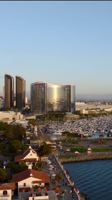 Aerial view of the harbor, the skyline and boats at Embarcadero, with a crowd gathered.