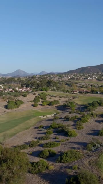 Aerial view of the country inland, homes and open country in Santaluz.